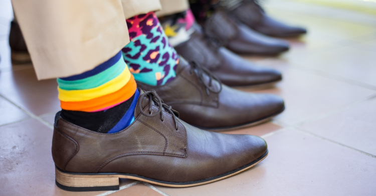 A row of feet, wearing colourful socks